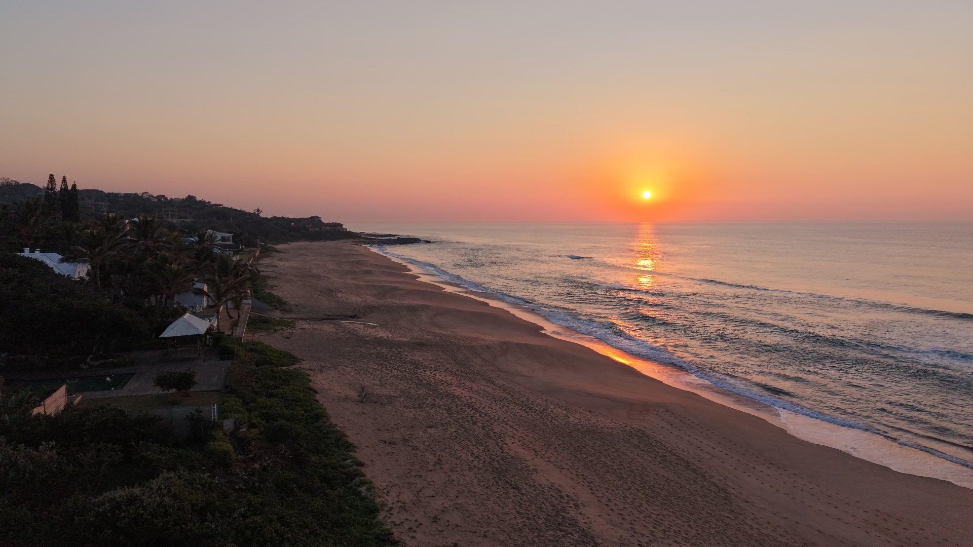 Coastal walkers at sunrise